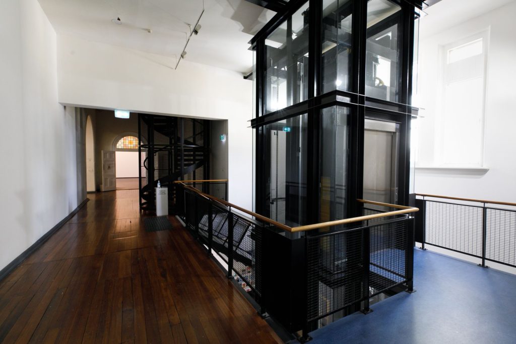 View of the lift and stairs from the first floor facing West End Gallery